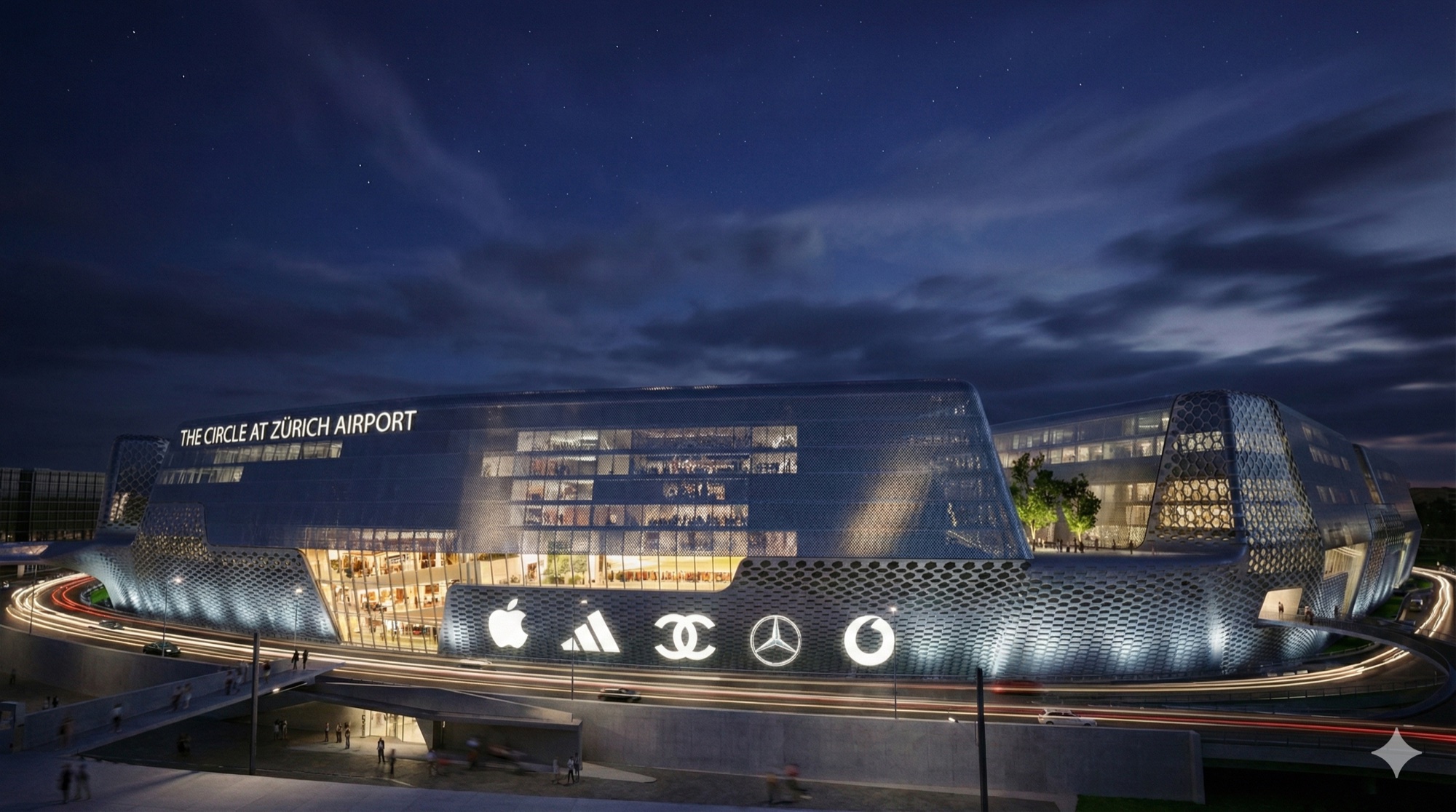 Night view of The Circle at Zurich Airport with illuminated brand signage and curving glass facade