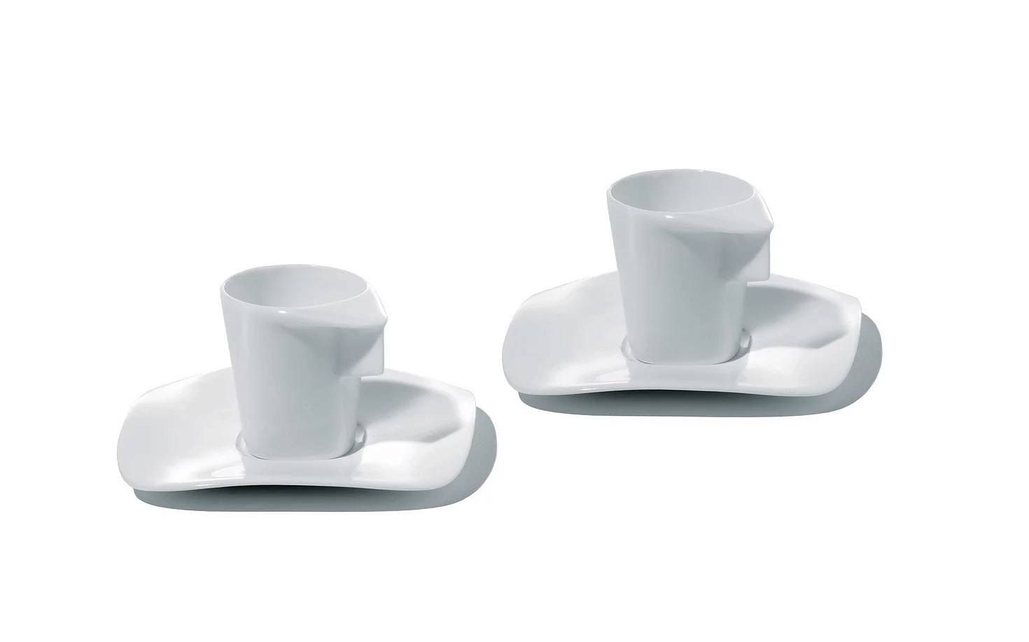 A pair of Alessi espresso cups on undulating porcelain saucers