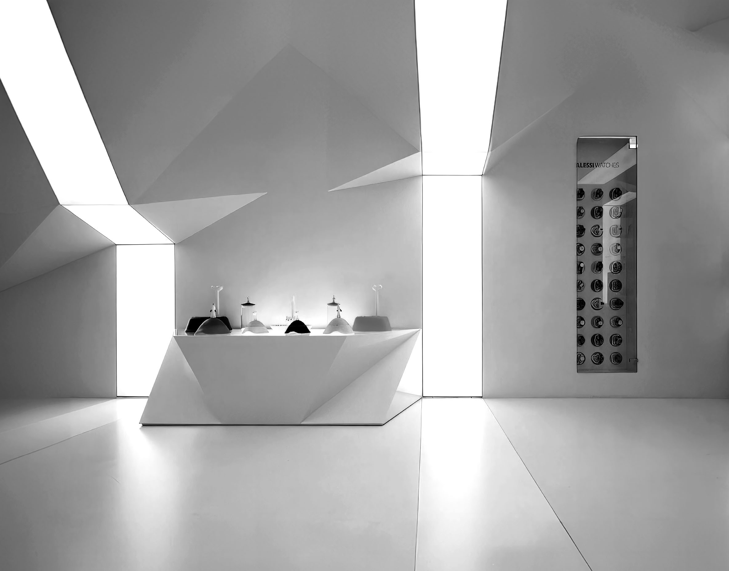 Faceted interior module with central display table, Alessi watches display, and intersecting bands of light