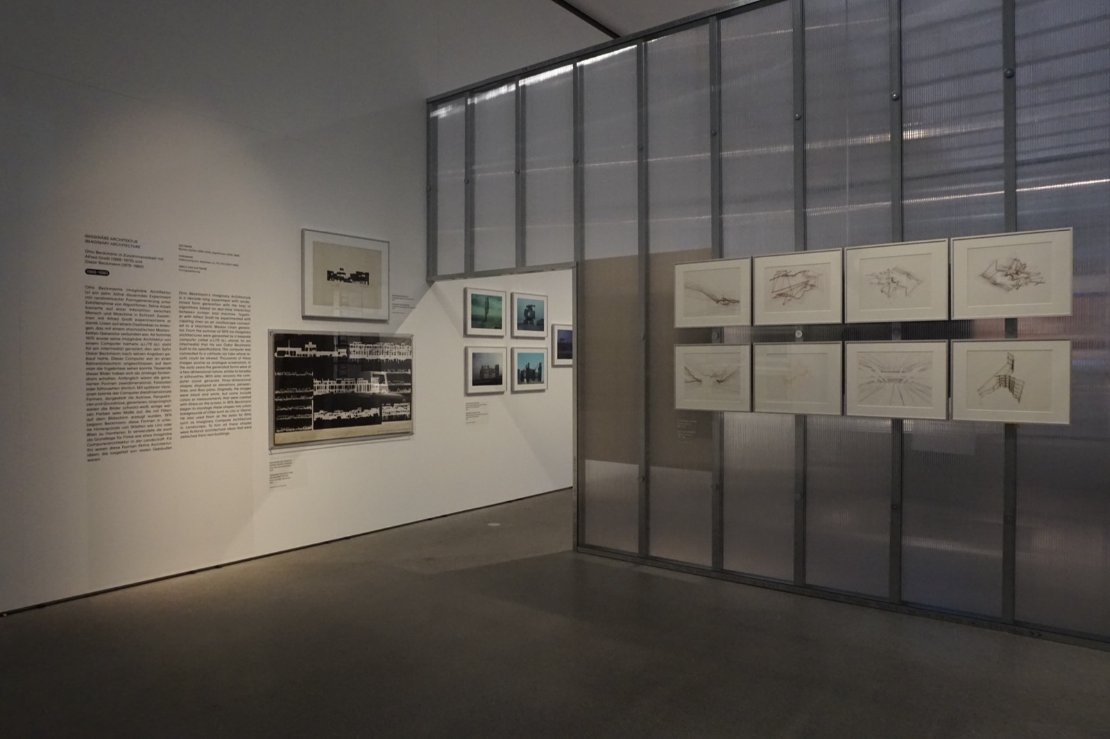 Exhibition section with architectural drawings, photographs, and wall text documenting early computational design