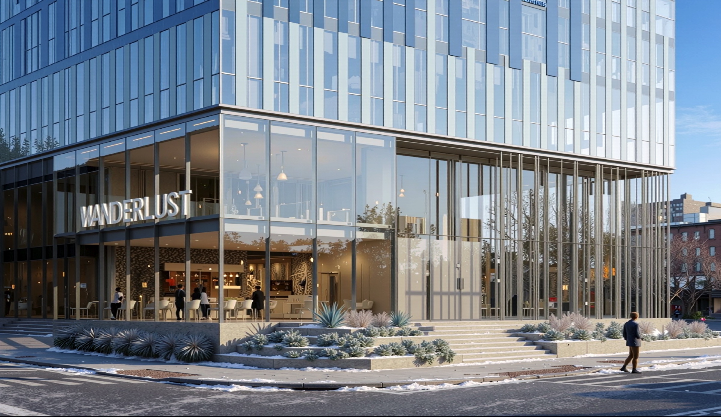 Street-level winter view of the ground-floor retail frontage with Wanderlust signage, full-height glazing, stepped entrance, and snow-dusted landscaping