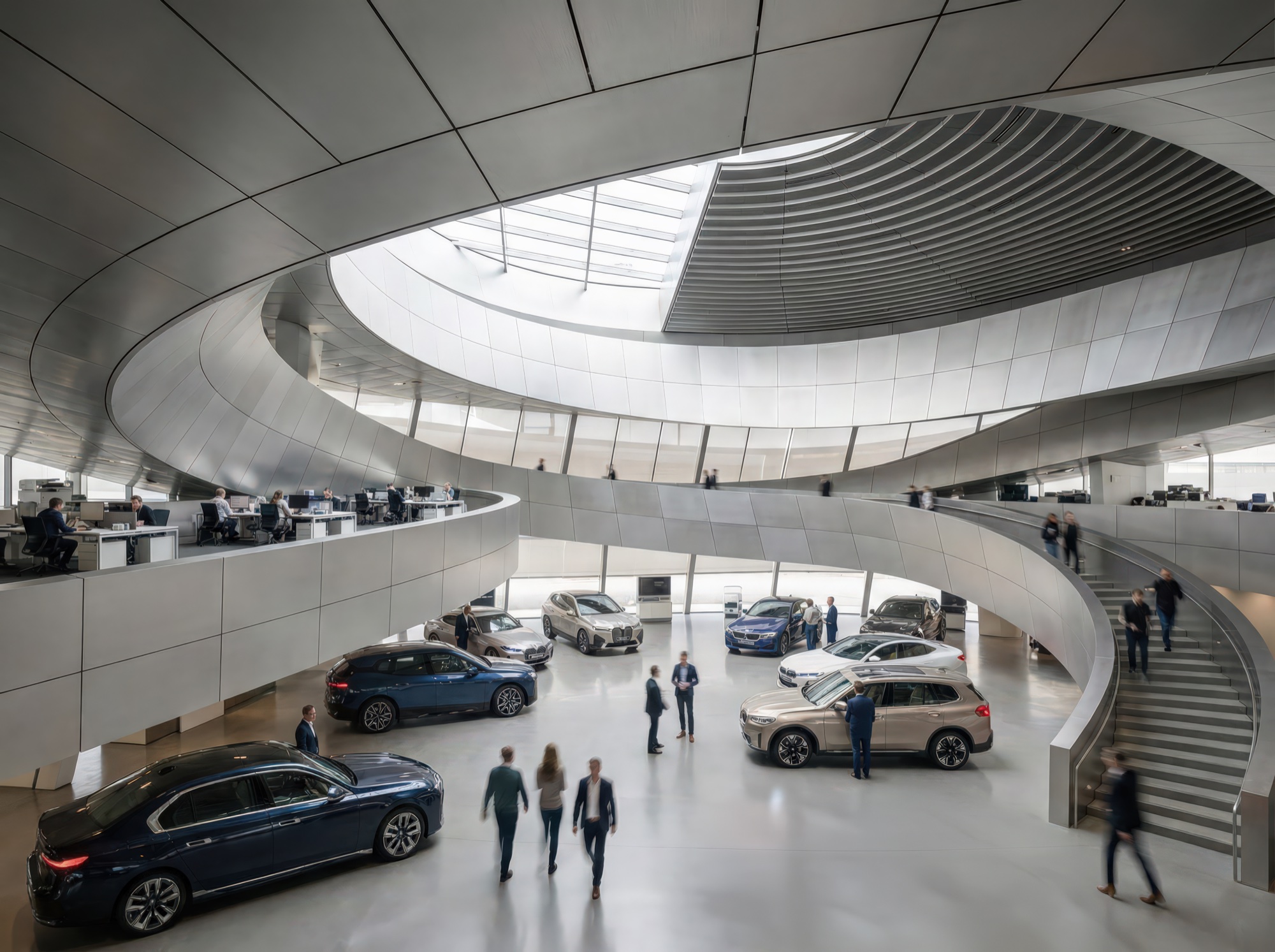 Vehicle delivery hall interior with spiraling mezzanine ramp, curved metallic ceiling, BMW vehicles on display, and visitors