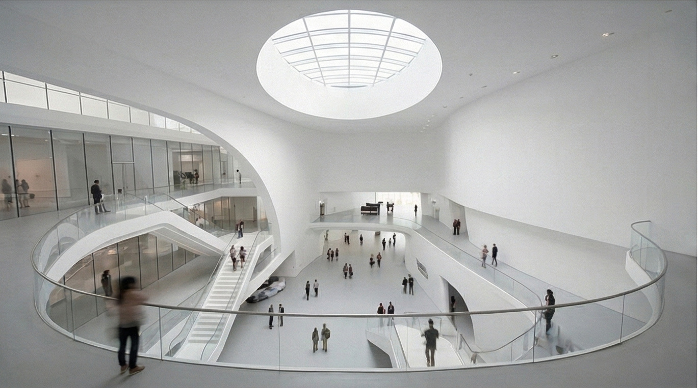 Atrium view showing the curved balcony edges, suspended walkways, and overhead daylight