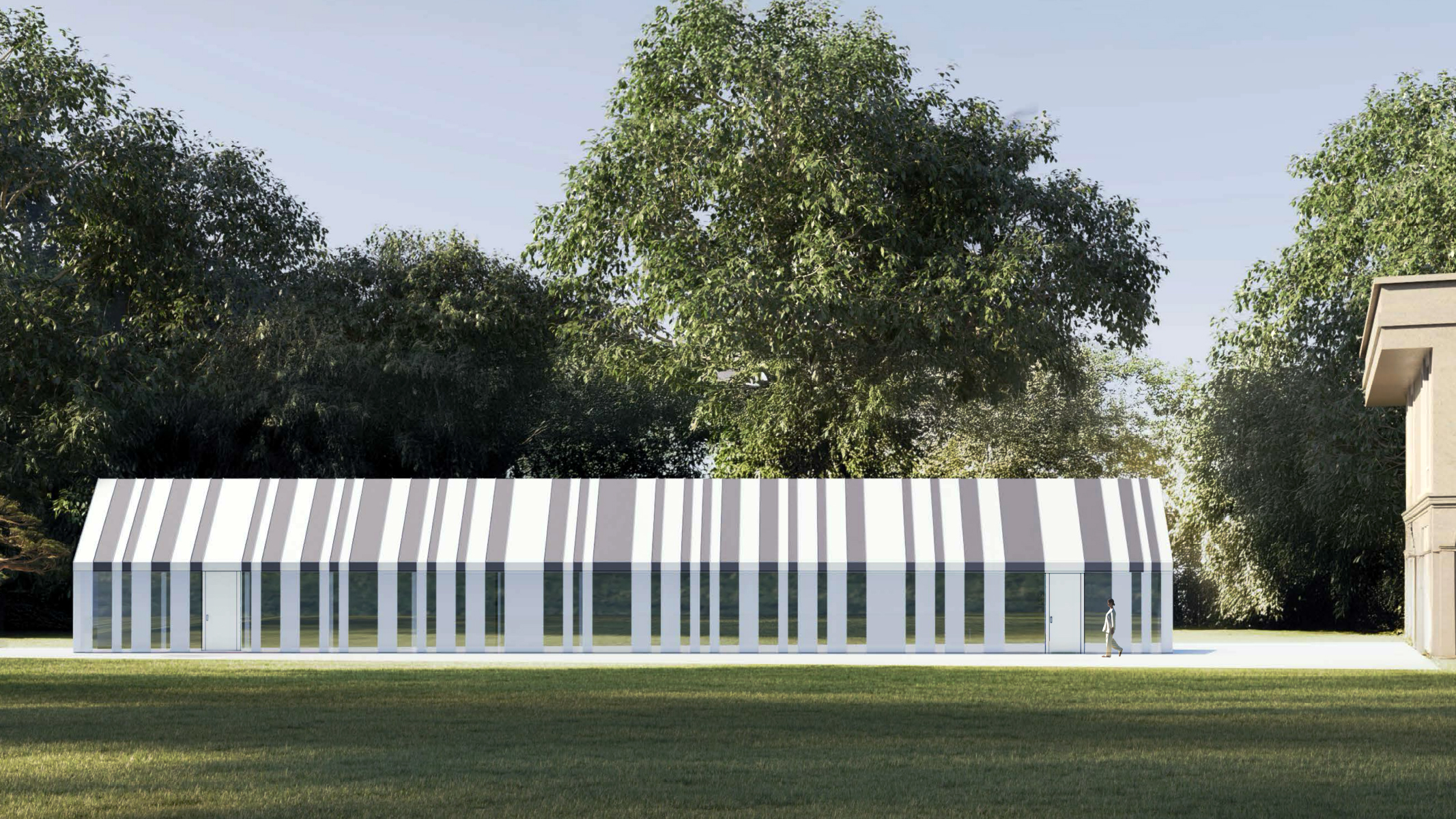 South elevation of the Butterfly Pool Pavilion seen from the lawn, the full length of the pitched volume reading across the frame with the striped roof and vertical column rhythm against a canopy of trees, a figure walking past at right