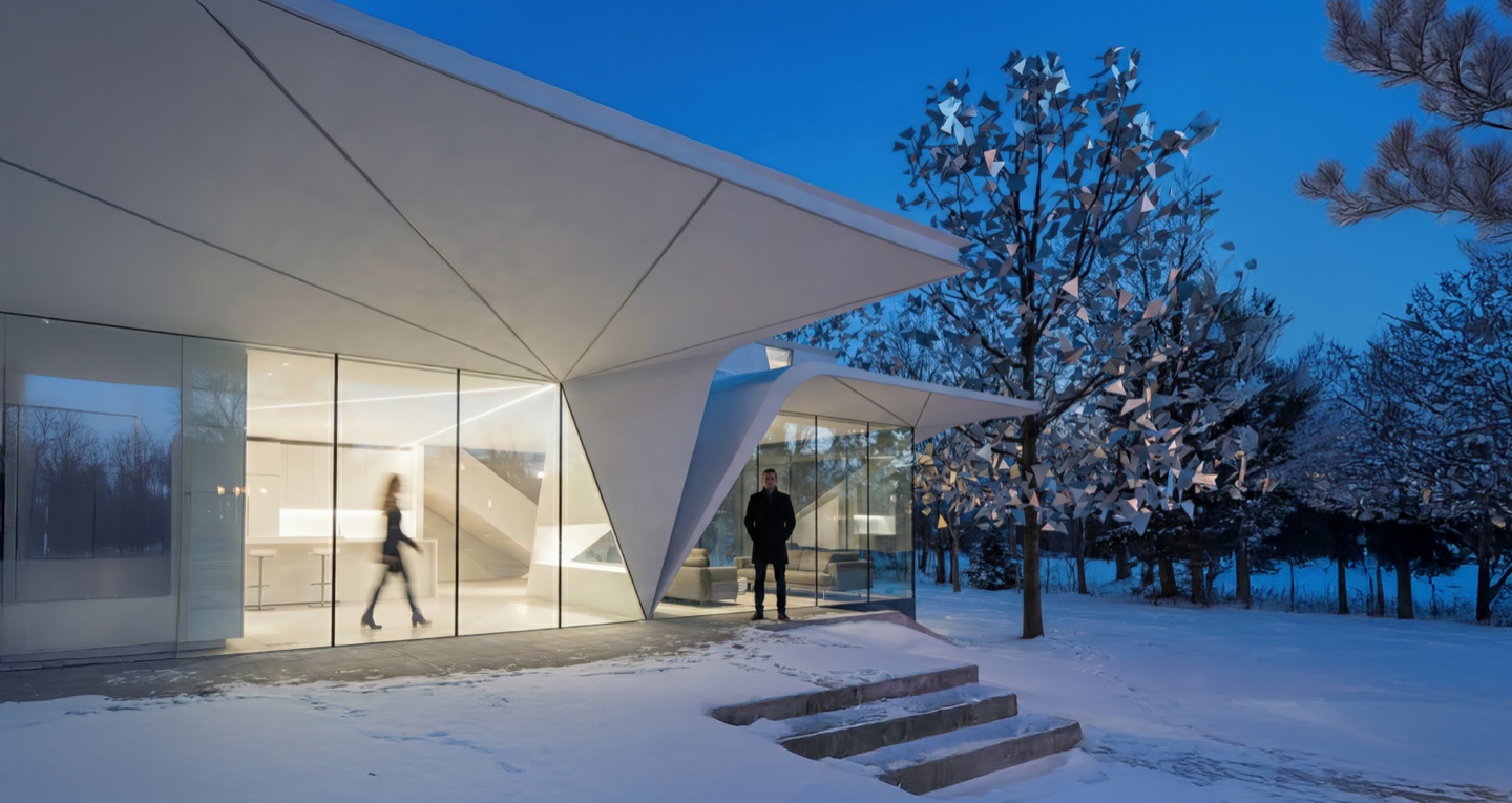 Cervelo House exterior at twilight with faceted white panels glowing against a winter landscape and deep blue sky