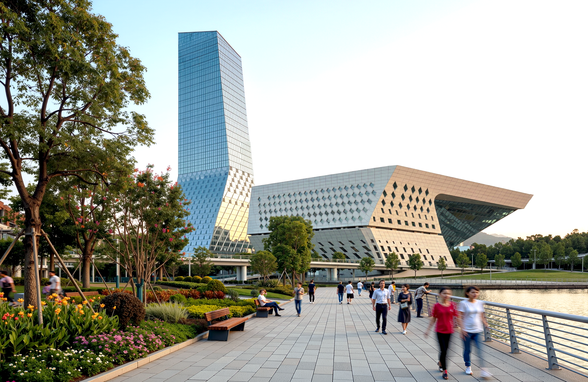 Street-level view from the waterfront promenade showing pedestrians, landscaped gardens, and the tower rising behind the angular performing arts volume