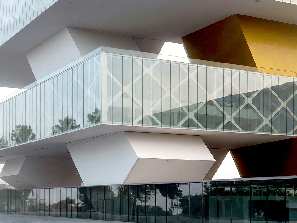 Exness Global Headquarters interlocking volumes with yellow accents along the Limassol coastline