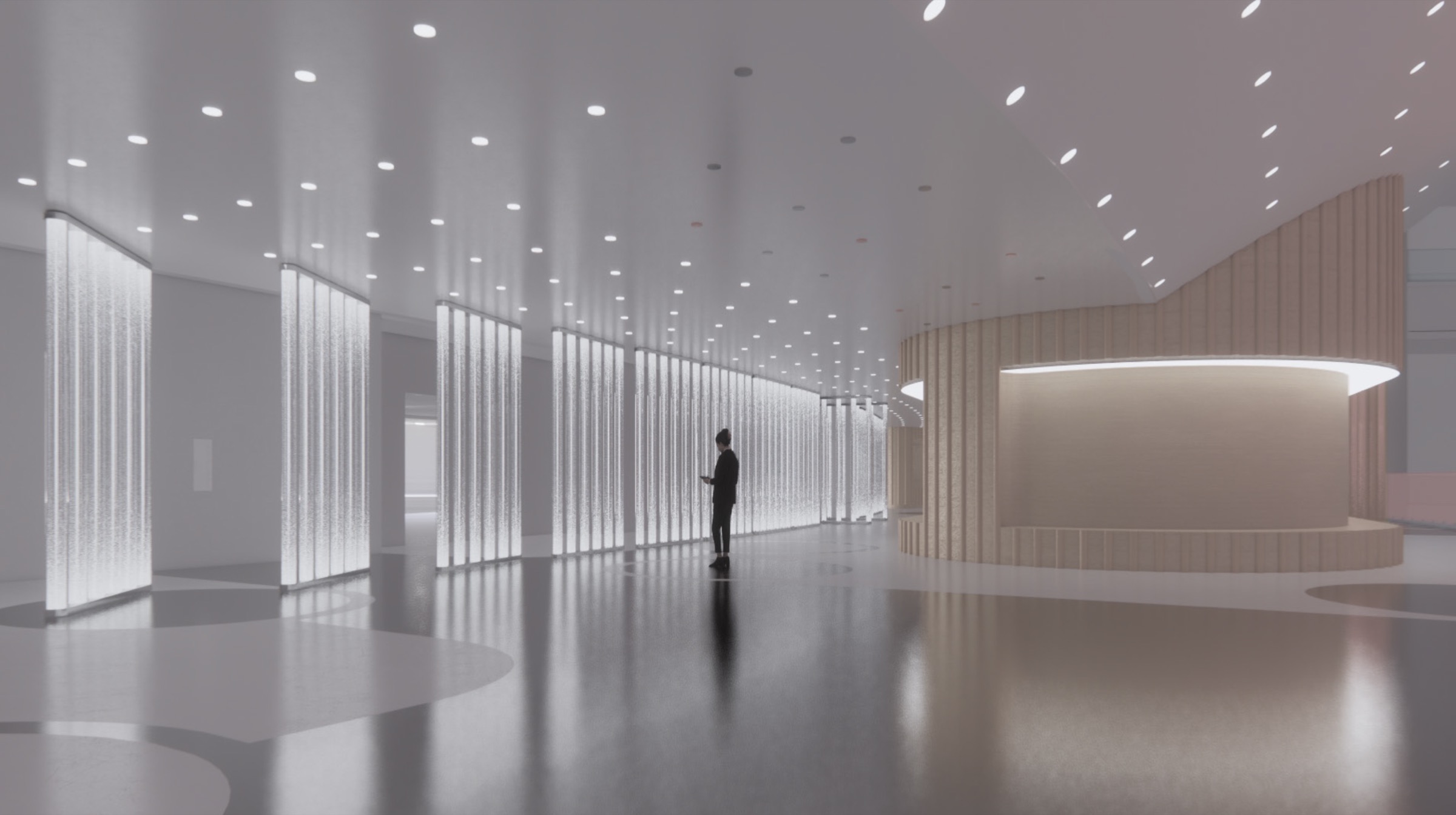 Wide view of the GALLERY lobby at the MSG Sphere showing luminous crystalline light panels lining a grand hall, a solitary visitor, curved timber reception desk, and a field of recessed ceiling lights