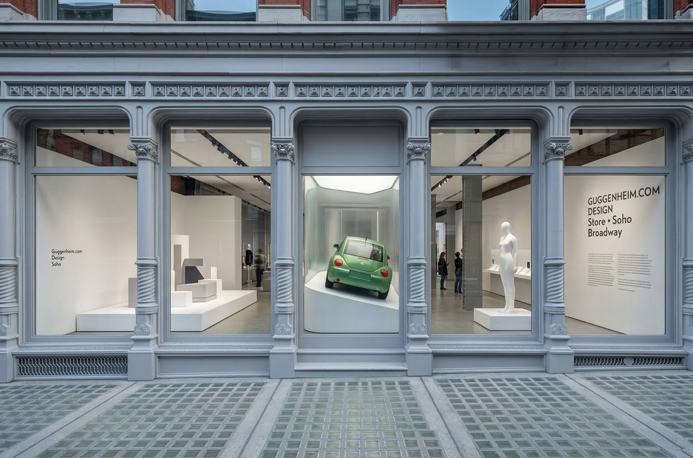 Exterior view of the Guggenheim.com store set within a cast-iron SoHo Broadway facade, large display windows revealing glass vitrines and curated objects inside