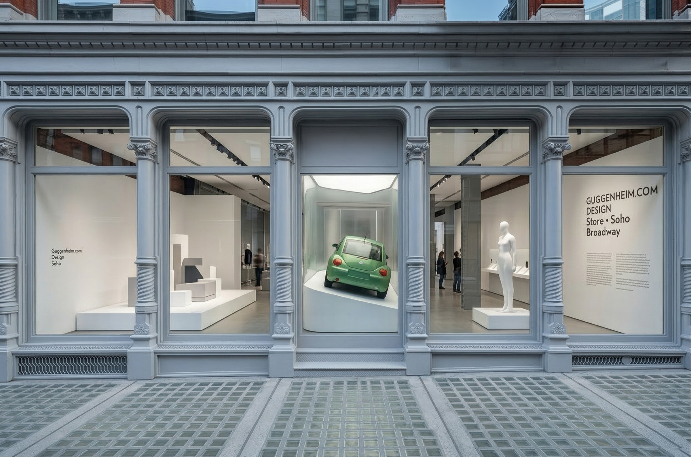 Exterior view of the Guggenheim.com store set within a cast-iron SoHo Broadway facade, large display windows revealing glass vitrines and curated objects inside