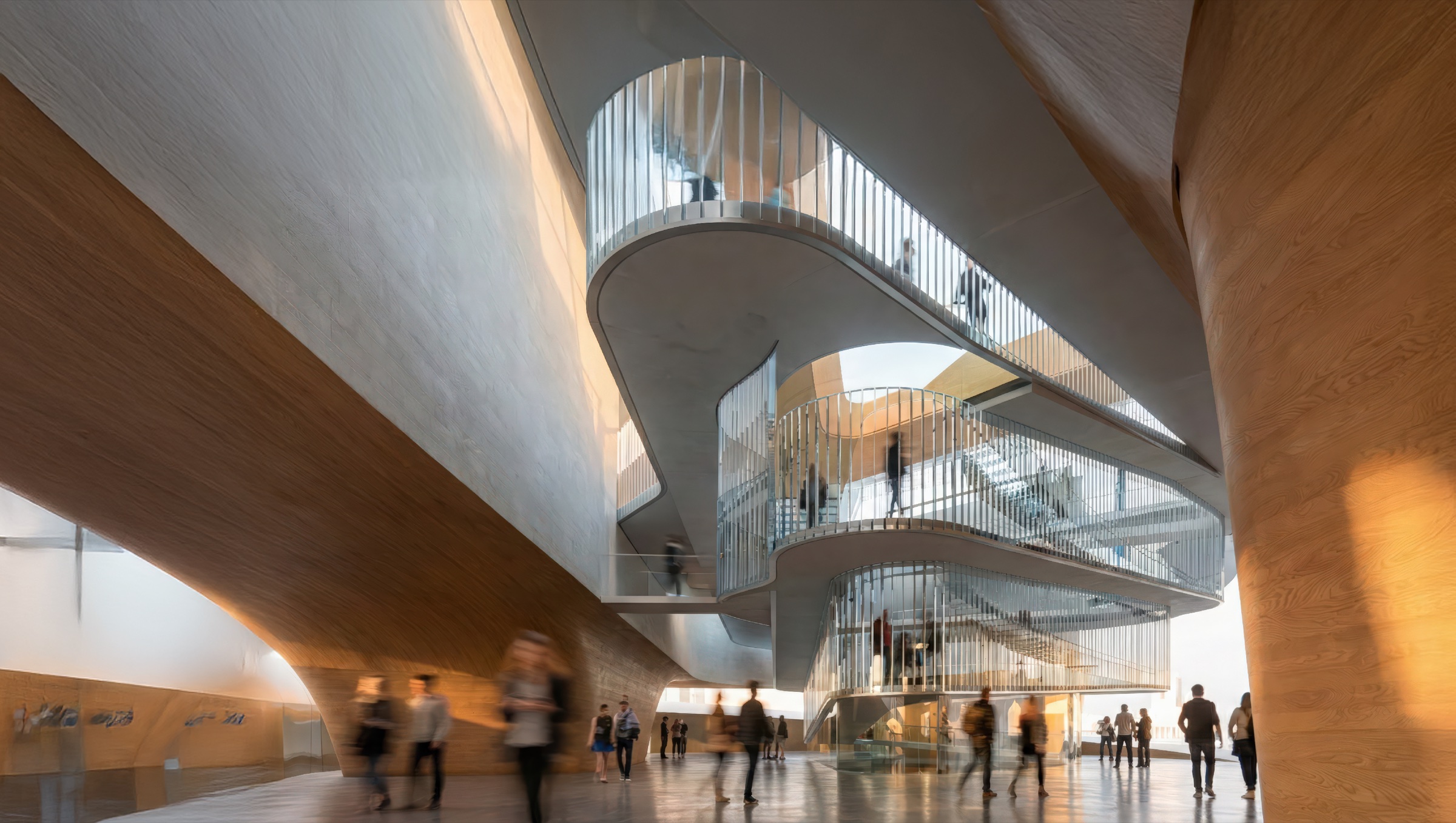 Interior view of the central atrium with spiraling glass-railed ramps, warm timber-clad volumes, and visitors circulating through multiple levels
