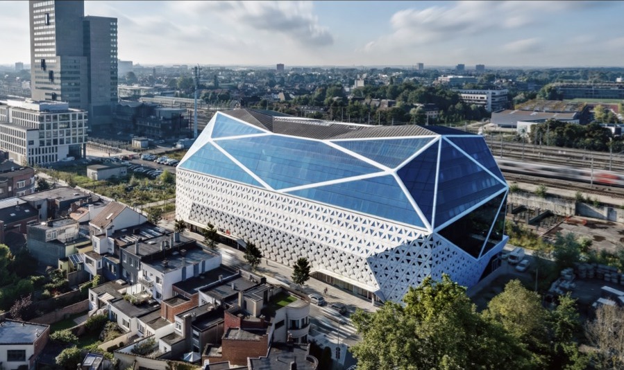 ING Headquarters aerial view showing the crystalline glass volume and surrounding Ghent neighborhood