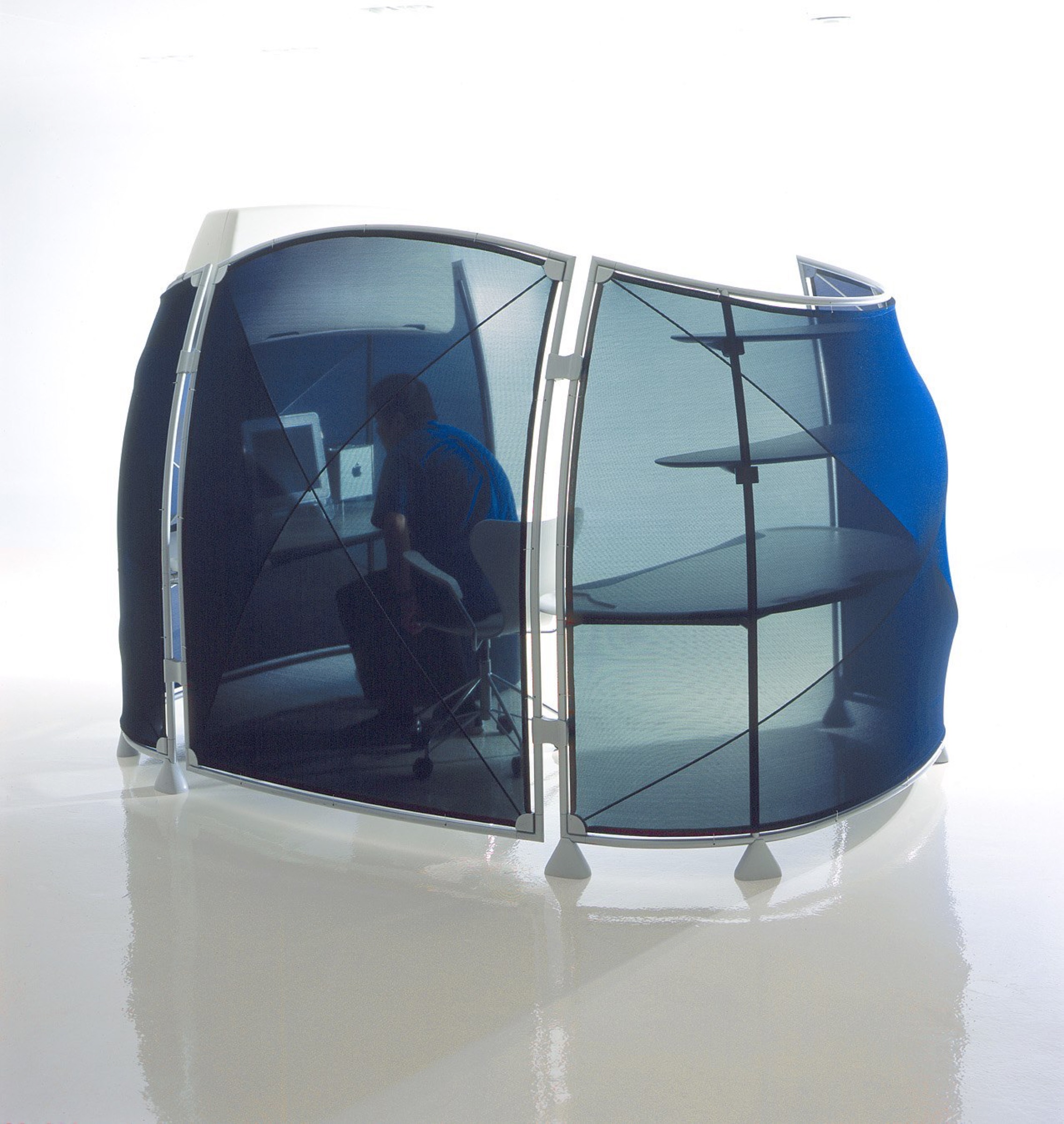 Single A3 workstation pod with translucent blue screens stretched across elliptical steel frames, enclosing a user at a curved worksurface