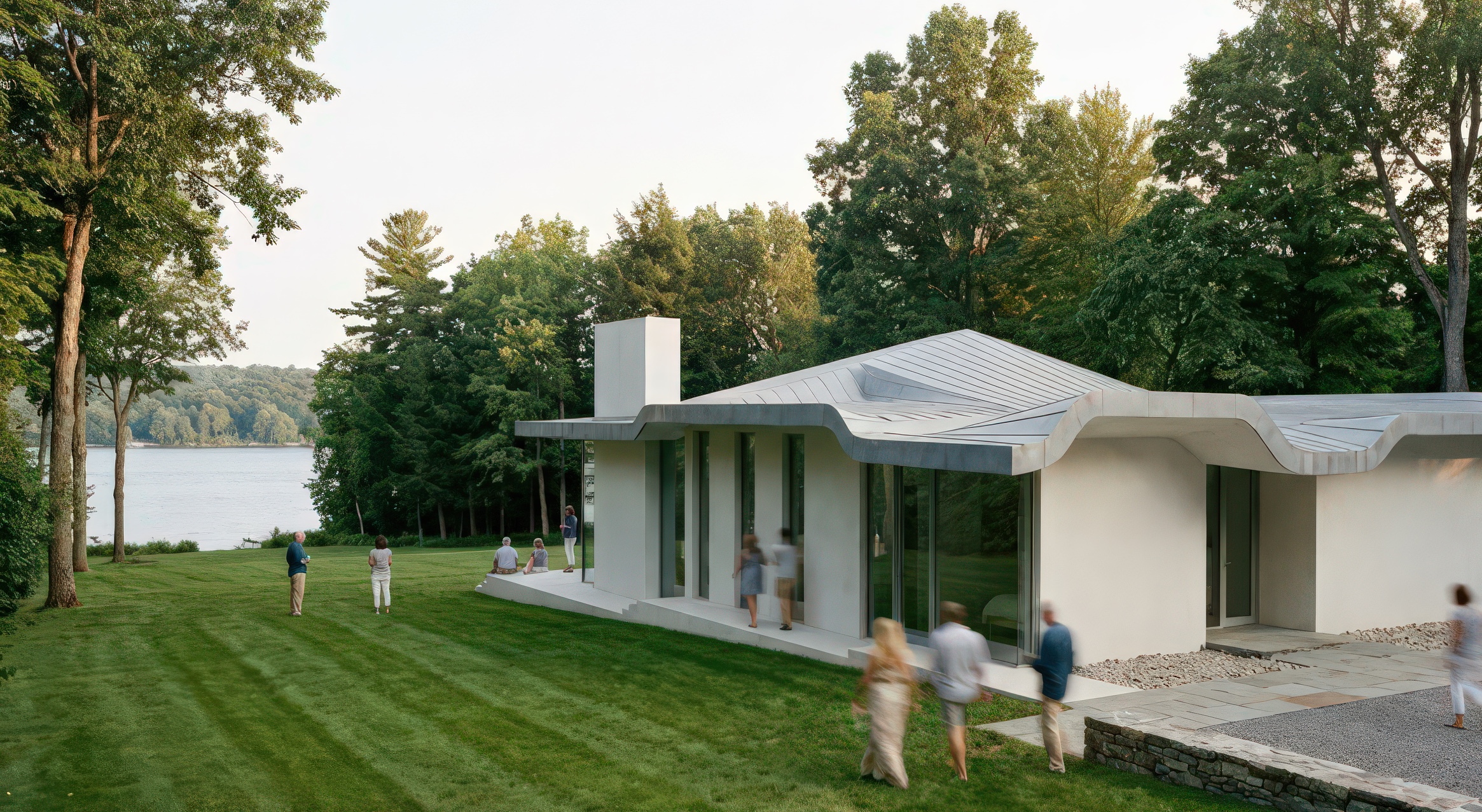 Side elevation of the Lakeview House showing the flowing roofline, white walls, and lakeside lawn