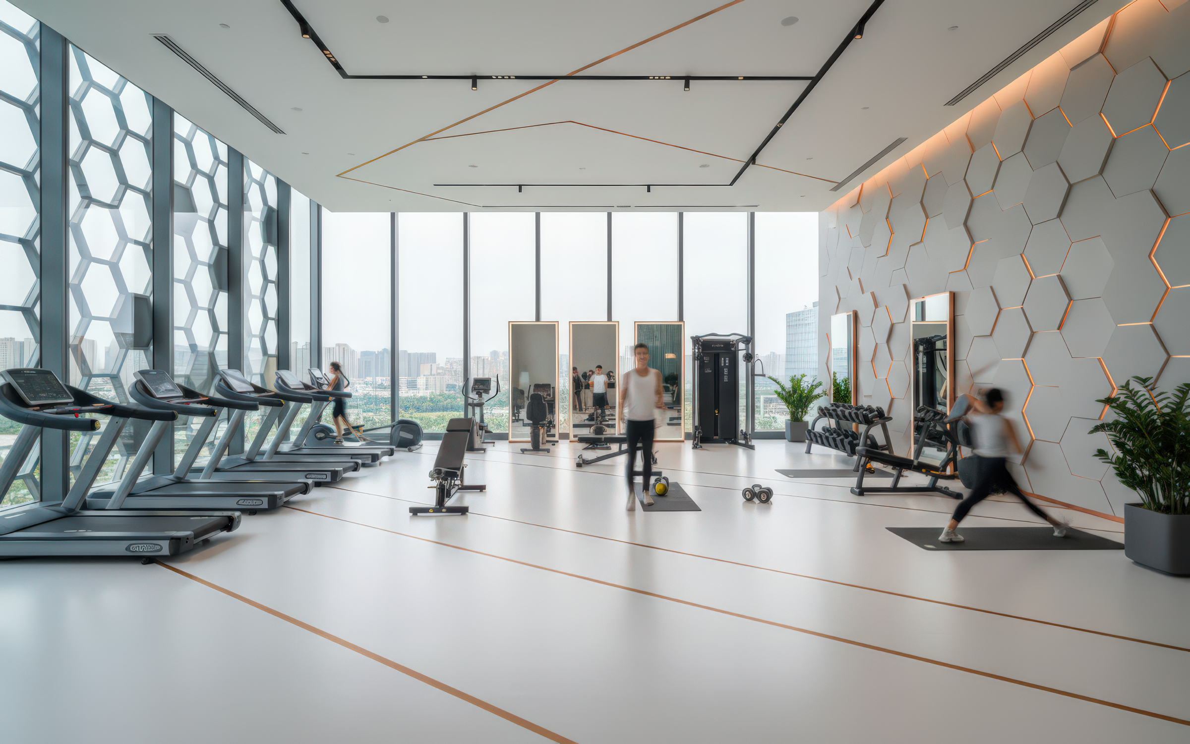 High-floor fitness center with hexagonal facade glazing, exercise equipment along the window wall, white hexagonal accent wall with amber LED outlines, and guests exercising