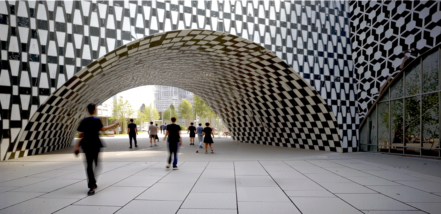 Students walking through a large covered archway with a dramatic tessellated black and white patterned vault overhead