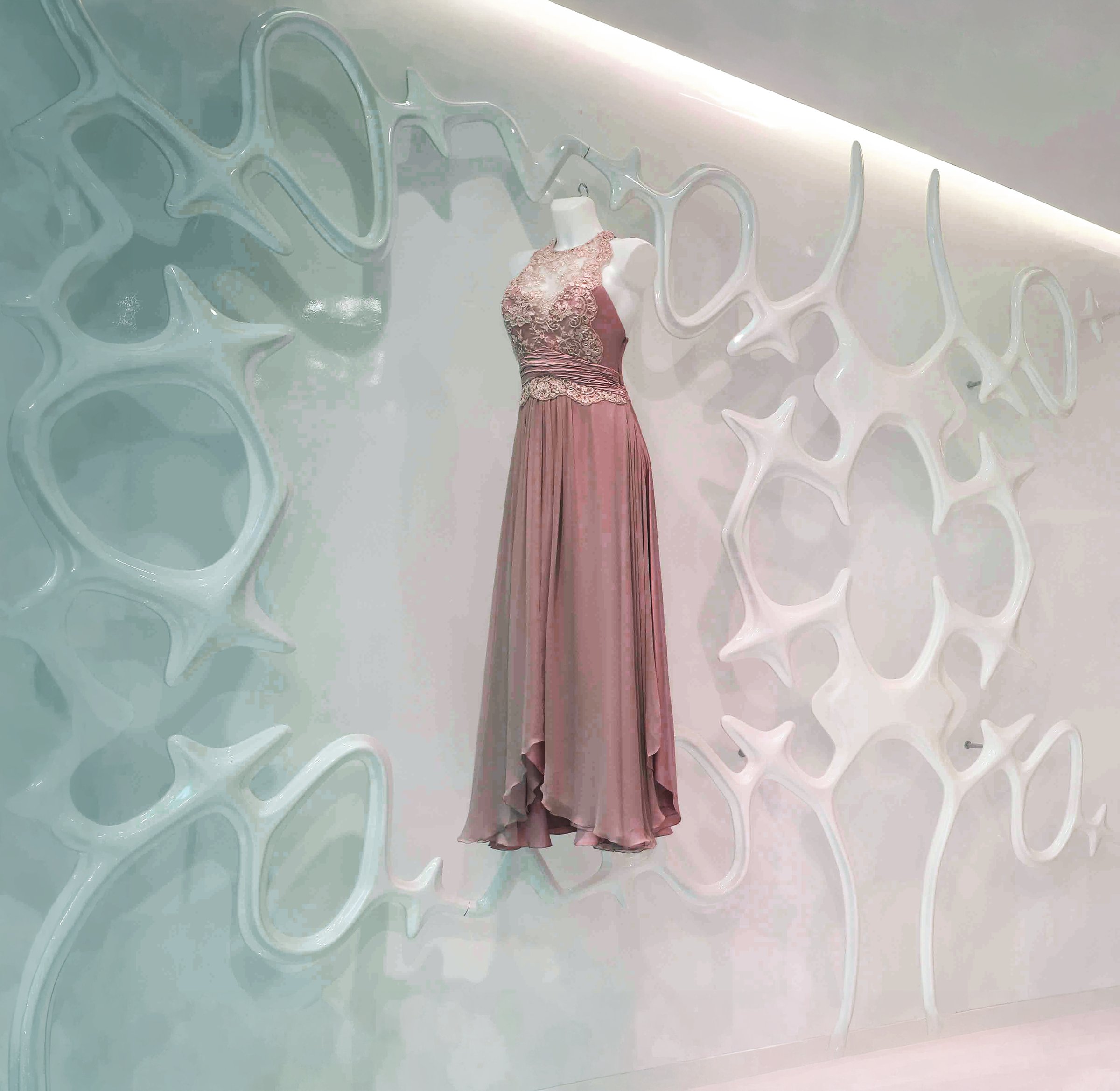 Mantella Screening Sculpture installed at the Carlos Miele flagship store in Paris — biomorphic white lattice wall with a couture dress displayed against it