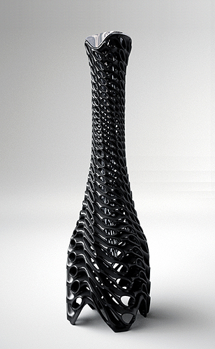 The Roi vase — a tall lattice-stemmed form in black epoxy with intricate perforations rising from a broad base to a narrow chromed mouth