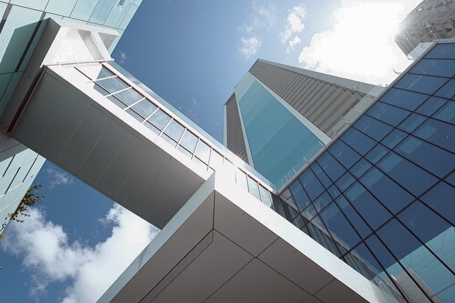 Upward view of the Missoni Baia tower highlighting the geometric glass and white structural elements against the sky