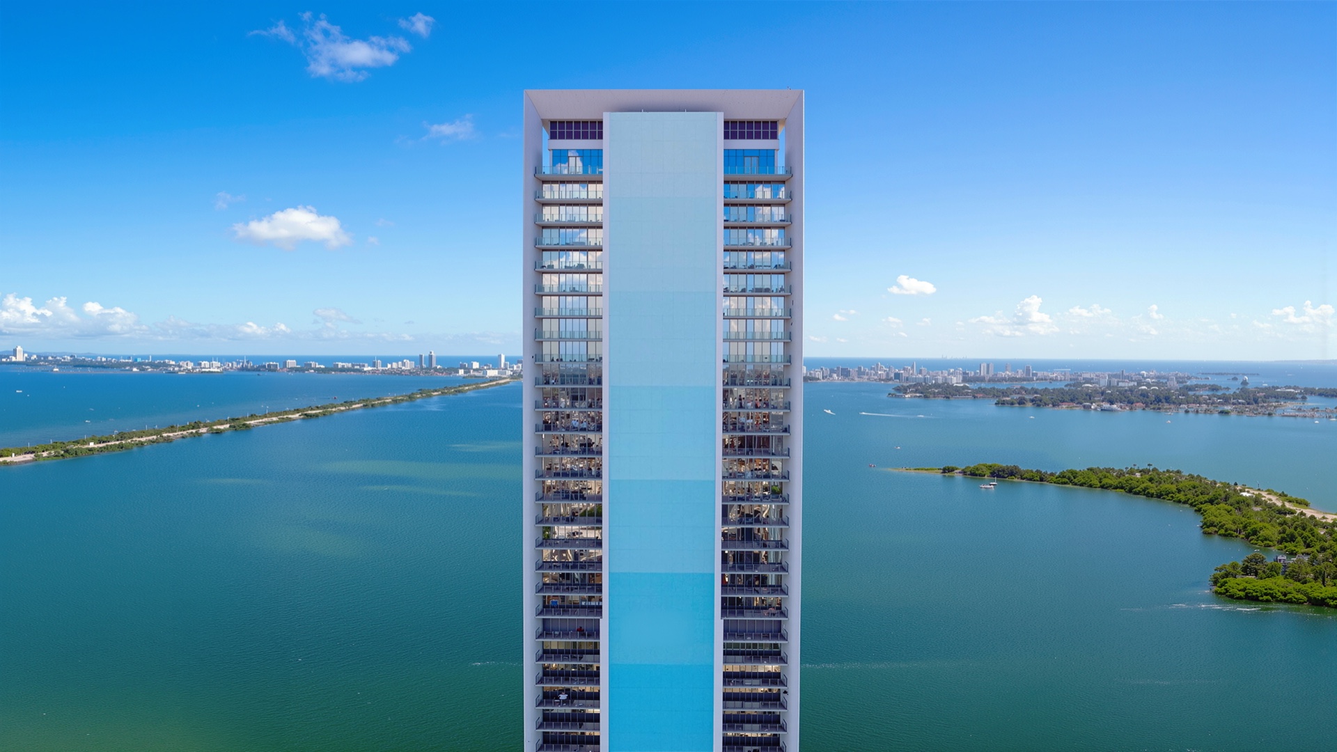 Aerial view of the Missoni Baia tower standing on the waterfront of Biscayne Bay with the Miami skyline in the background