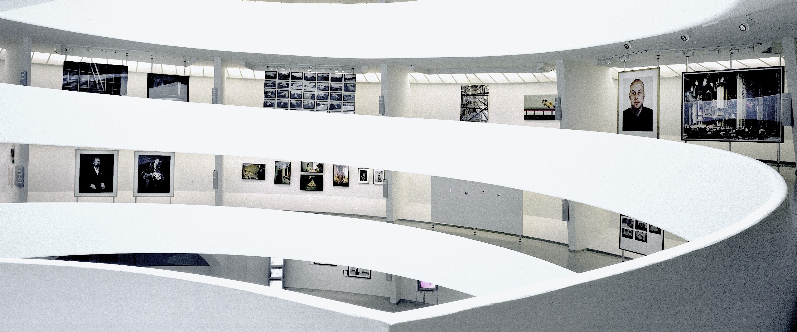 Moving Pictures exhibition at the Solomon R. Guggenheim Museum — panoramic view of the Frank Lloyd Wright rotunda with artworks hung along the spiraling ramps