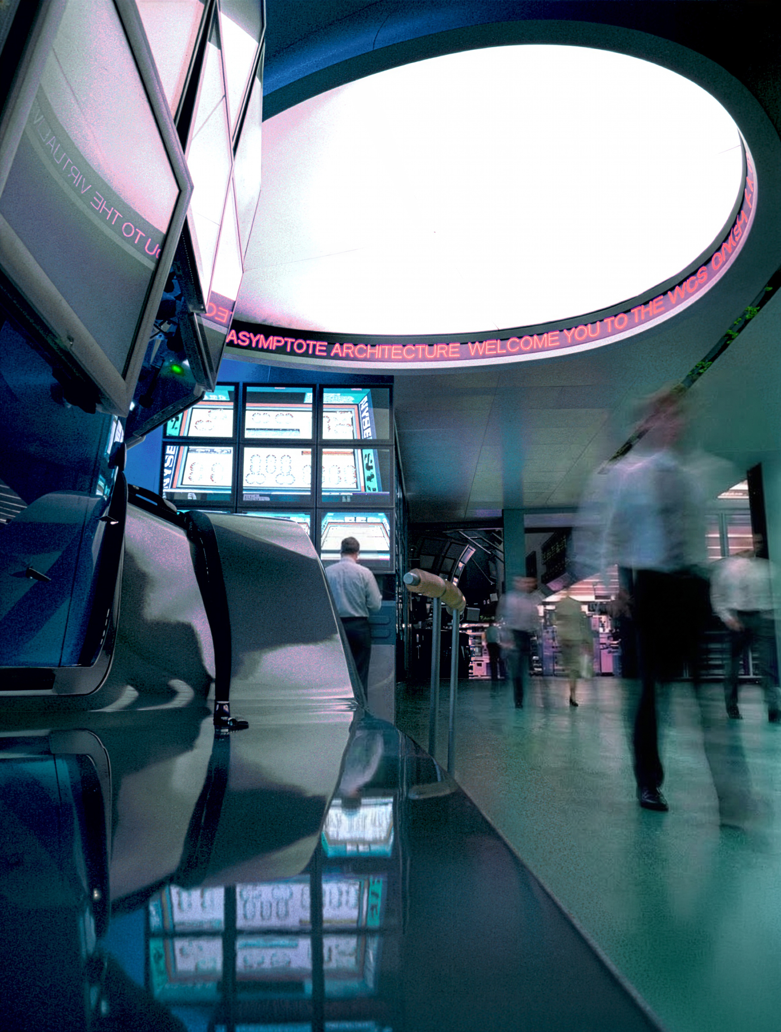 Low-angle view of the command center showing reflective surfaces, oval skylight, and scrolling Asymptote Architecture ticker