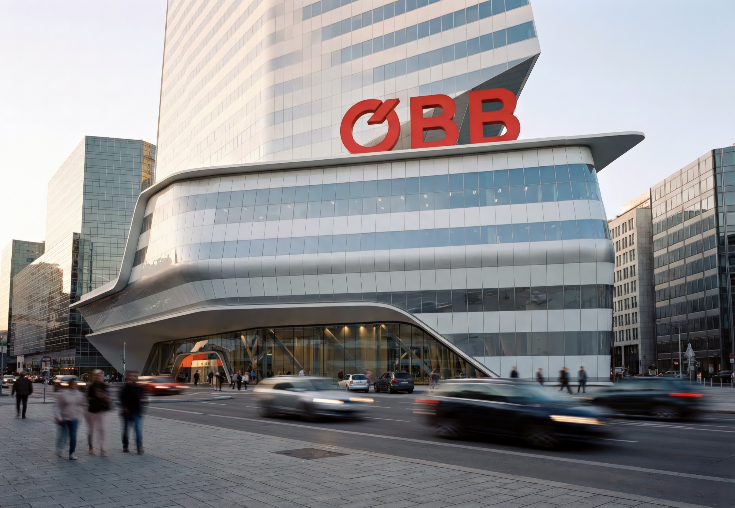 Approach to the ÖBB Headquarters entry with the ground-floor canopy, signage, and surrounding plaza