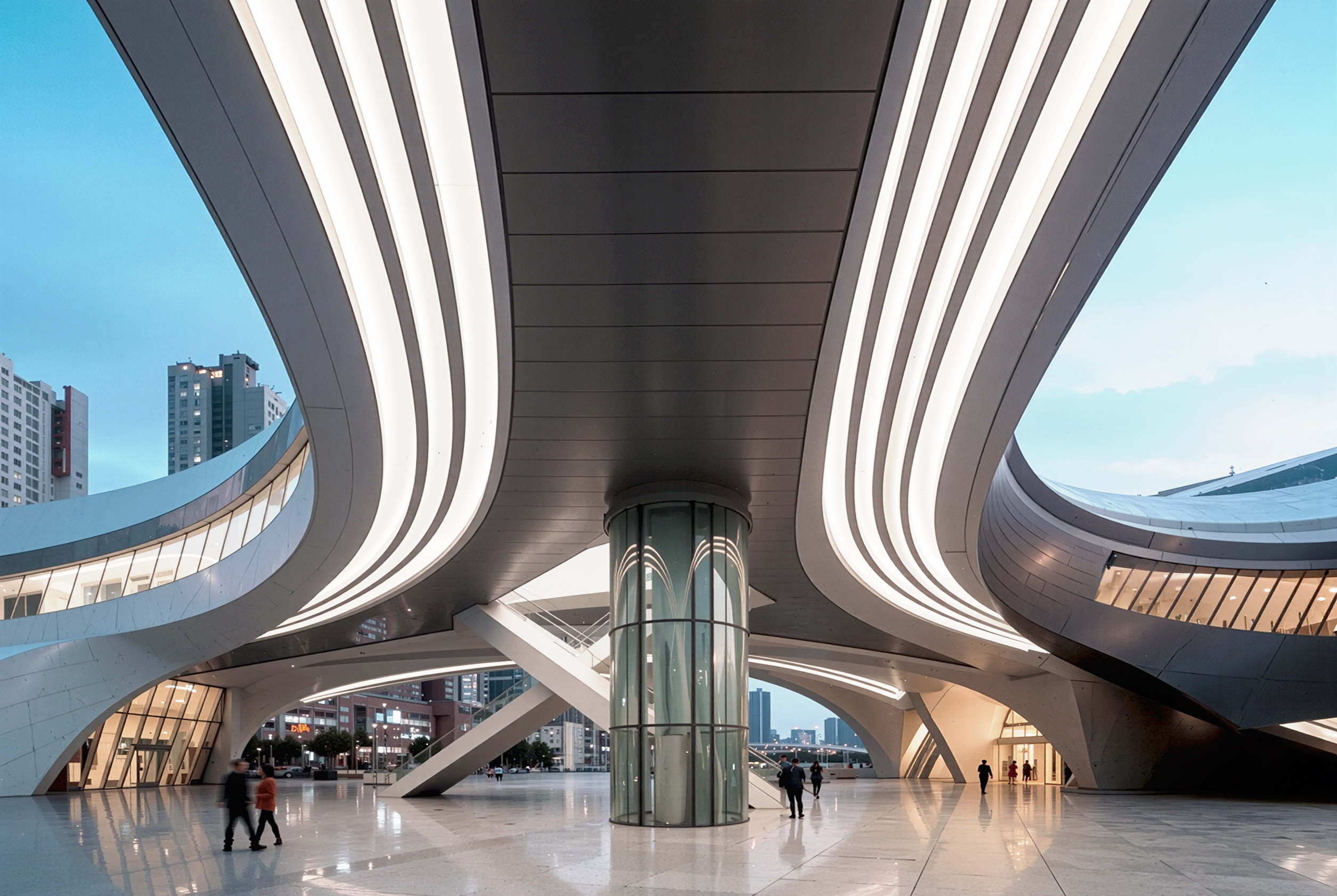 Dramatic ground-level view through the covered passage beneath the Busan Opera House, with sweeping structural forms converging overhead accented by LED light strips and a cylindrical glass elevator core