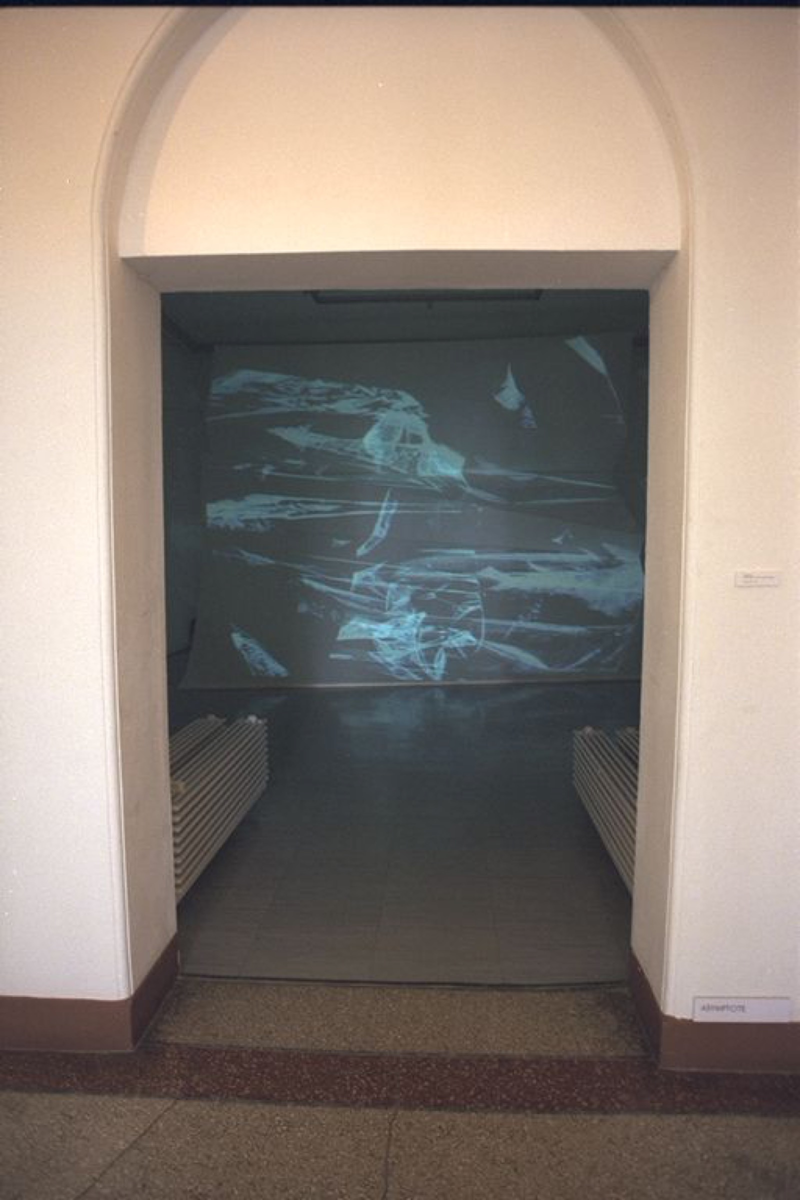 Interior view of the paper installation showing the relationship between folded surfaces and projected light