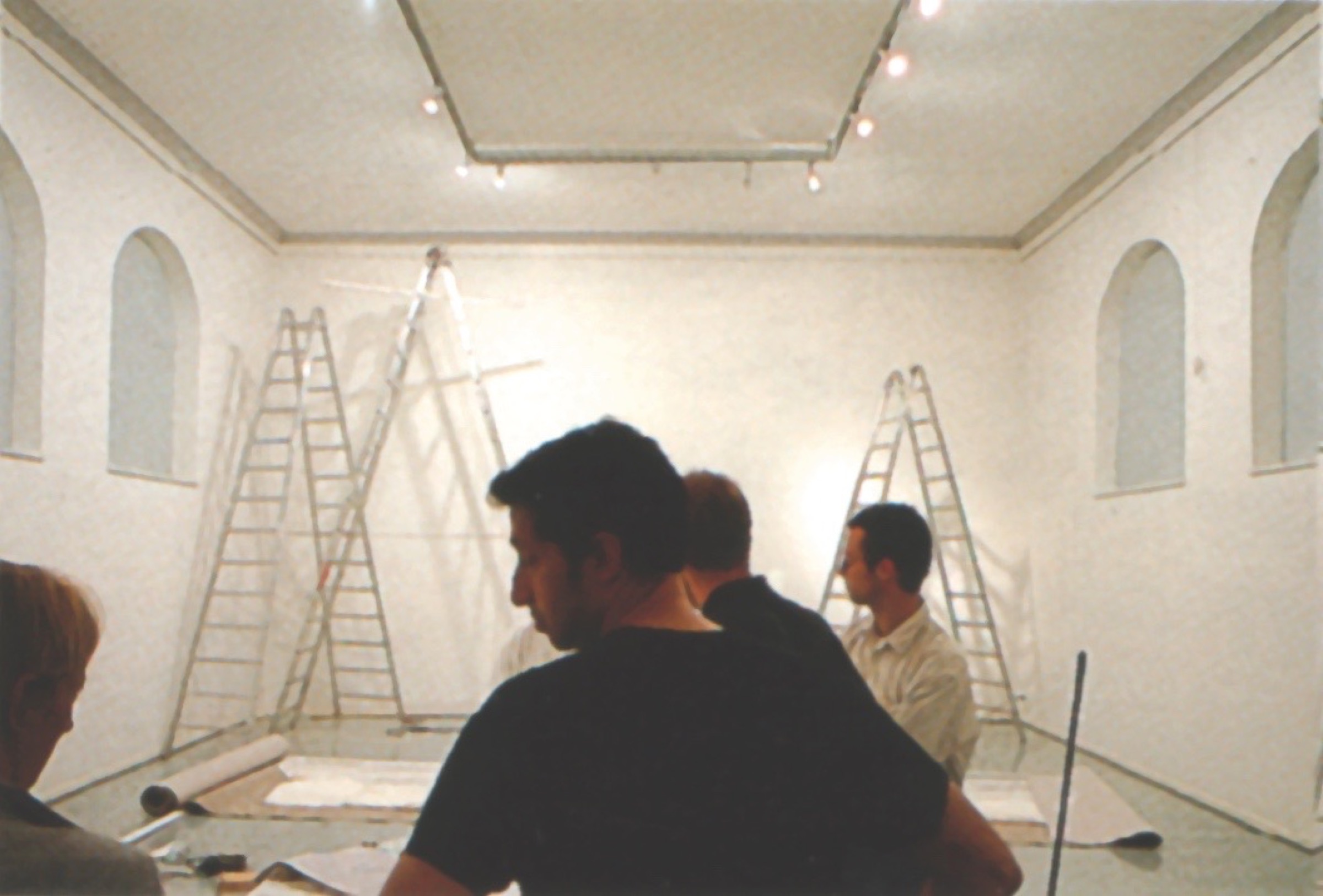 View of the paper installation in the gallery — faceted surfaces with projected imagery