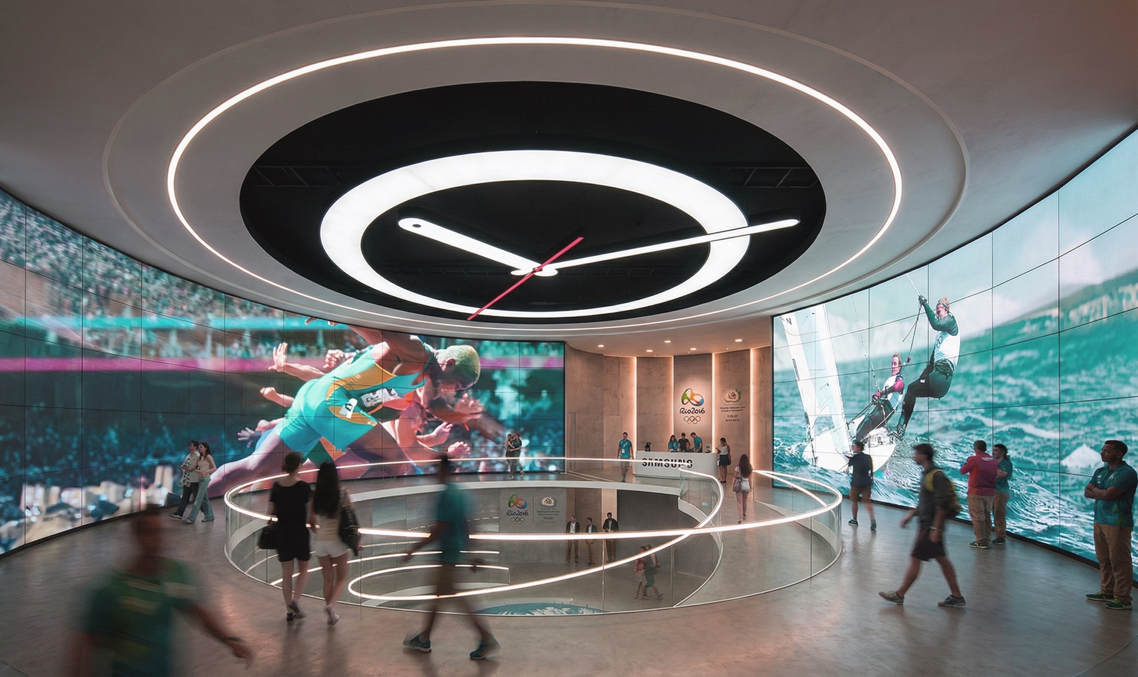 Immersive circular interior space with a dramatic overhead clock installation and curved panoramic screens showing Olympic athletes