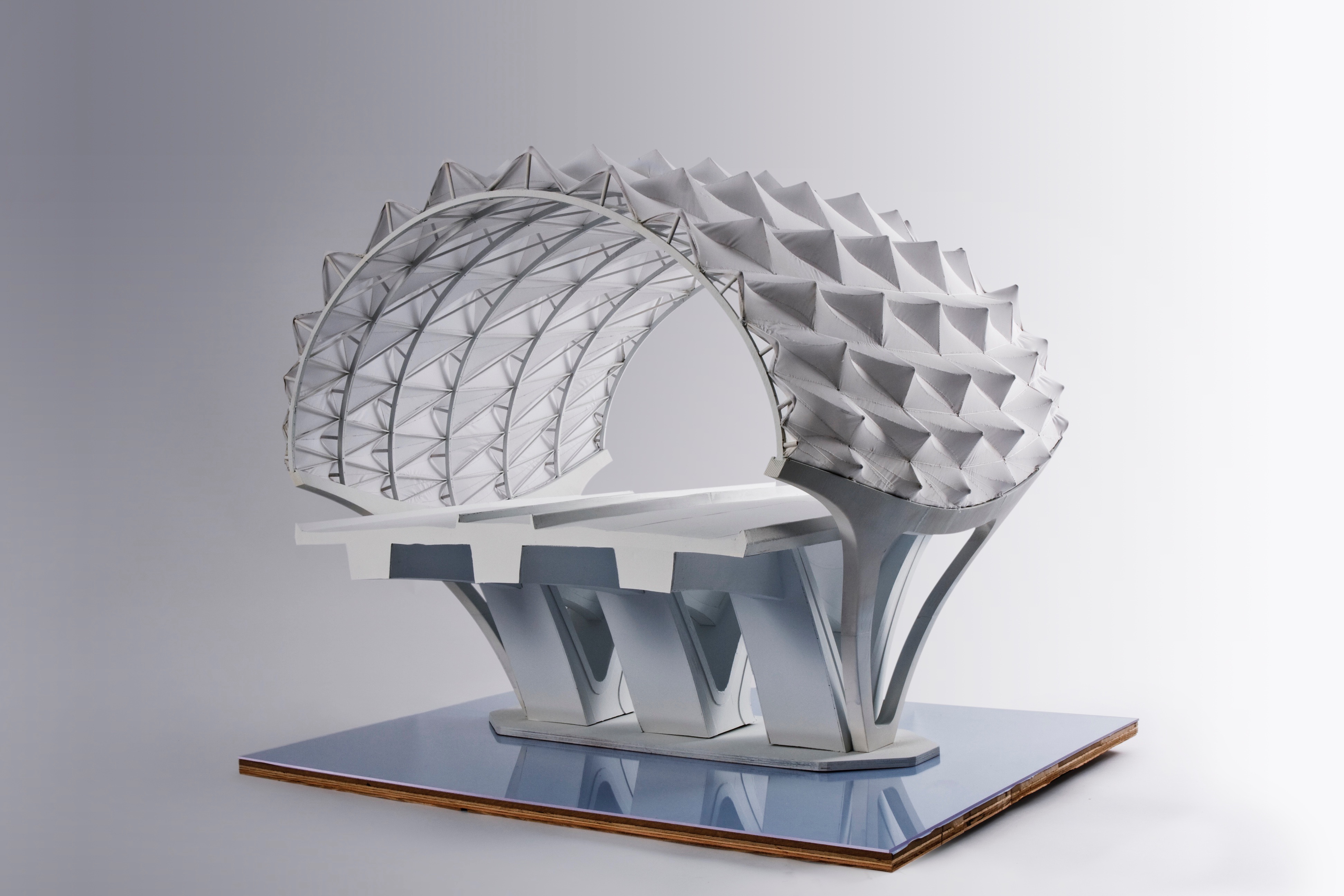 Sheikh Khalifa Bridge — physical model showing the structural shell, diamond mesh skin, and sculpted piers