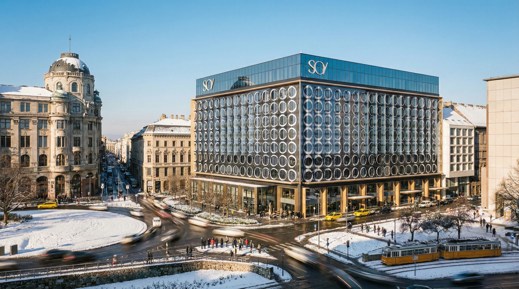 SO/ Budapest Hotel from an elevated perspective in winter — the building at the historic intersection with a tram, roundabout, and the surrounding city context