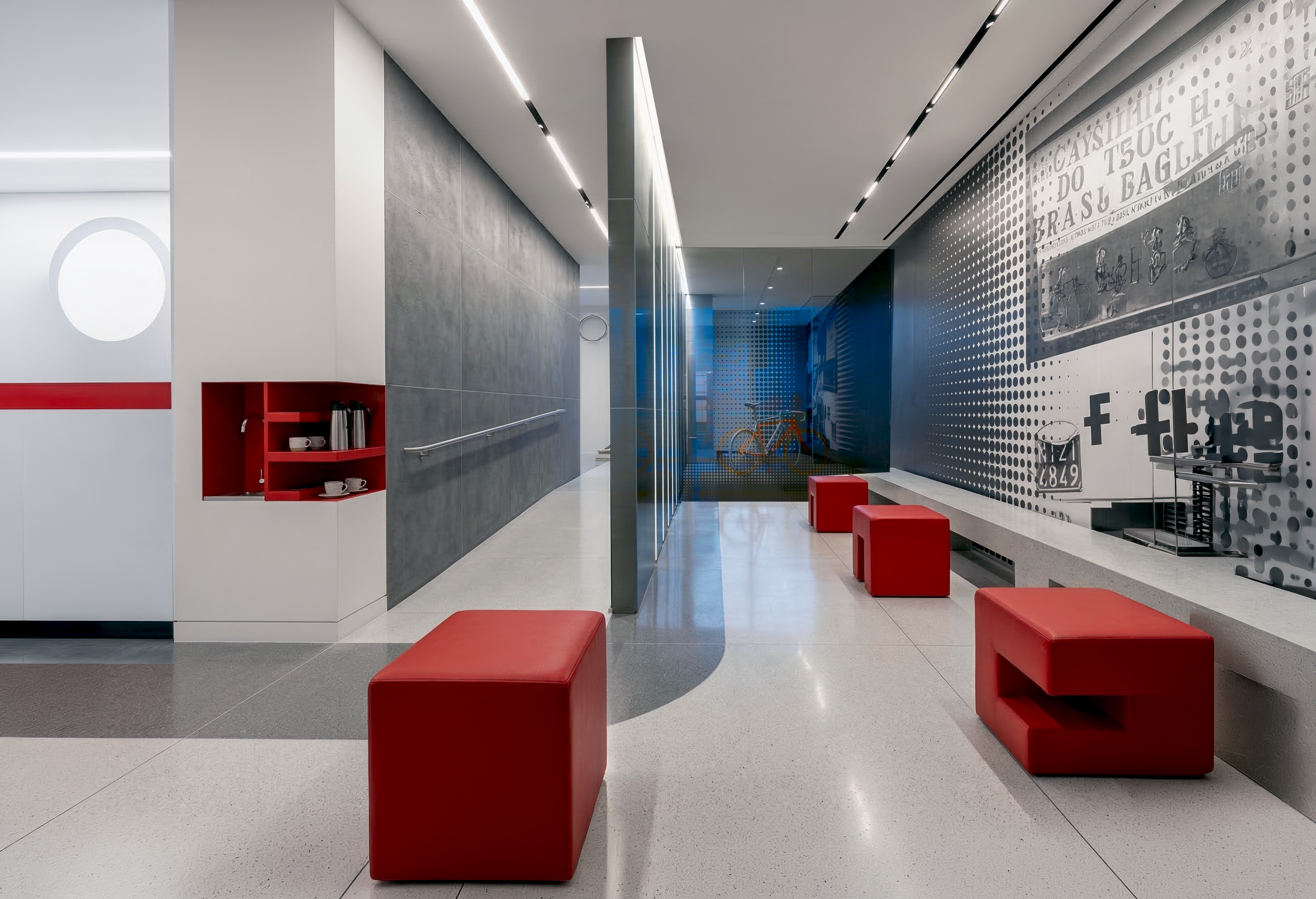 Lounge corridor with graphic mural wall and red seating