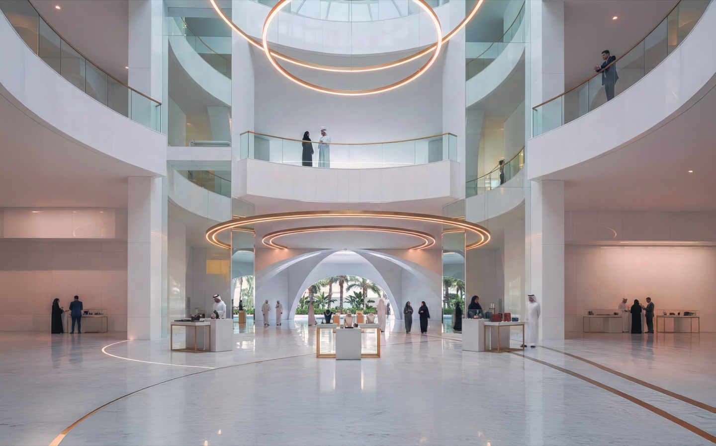 Soaring multi-level white atrium with curved balconies and golden ring chandeliers