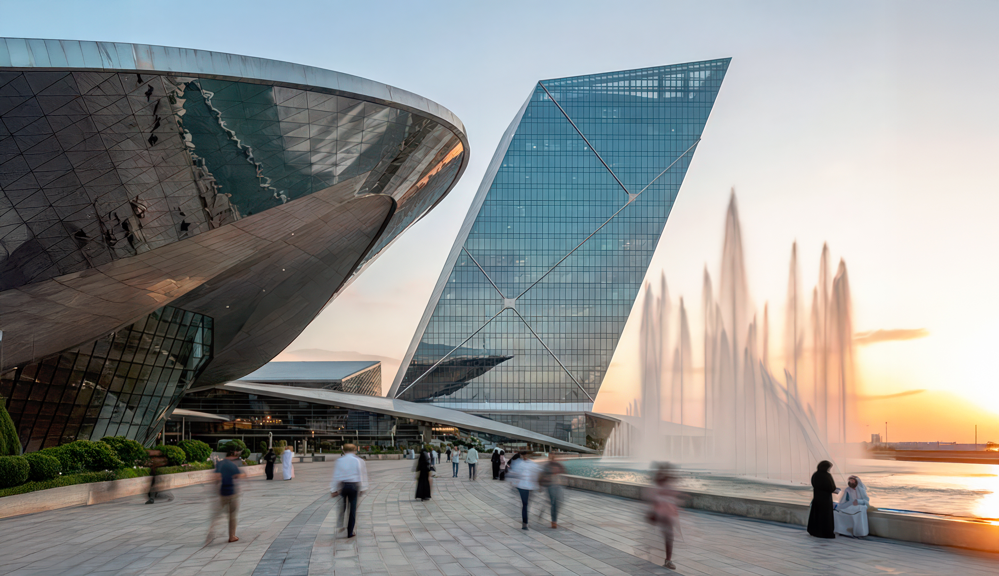 Close-up view of the pearl-shaped glass canopy and angular tower with fountains at the Dubai Pearl podium
