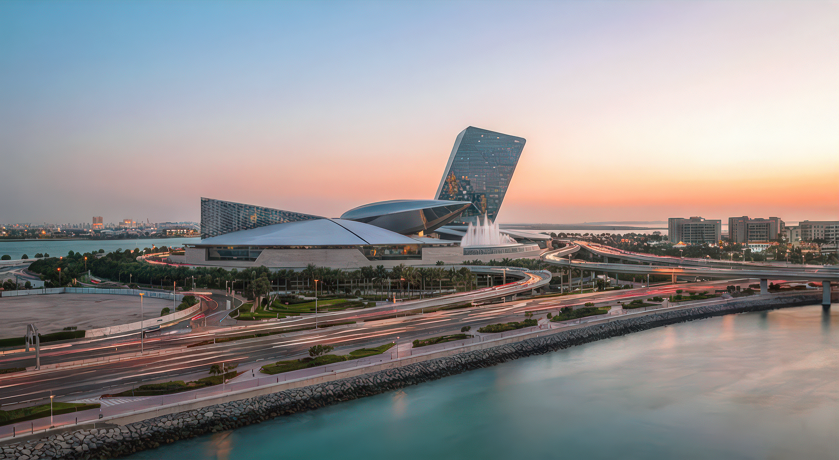 Waterfront dusk panorama of the entire Dubai Pearl development viewed across the water with light trails