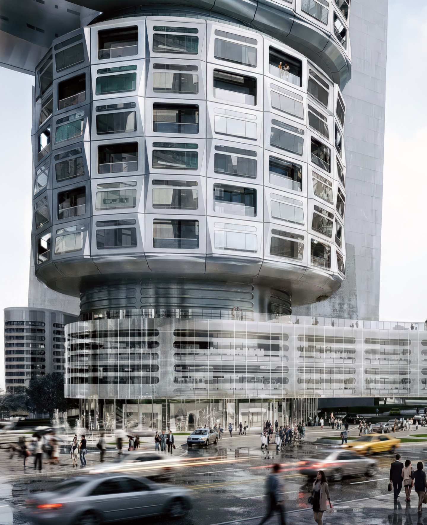 Street-level view of the cylindrical tower base with prefabricated facade panels