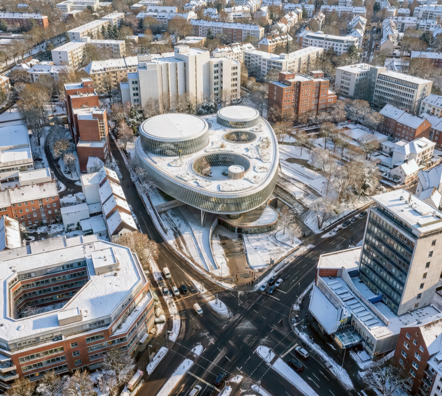 Aerial view of the Vorwerk Headquarters in winter with snow-covered rooftop gardens and circular oculi openings