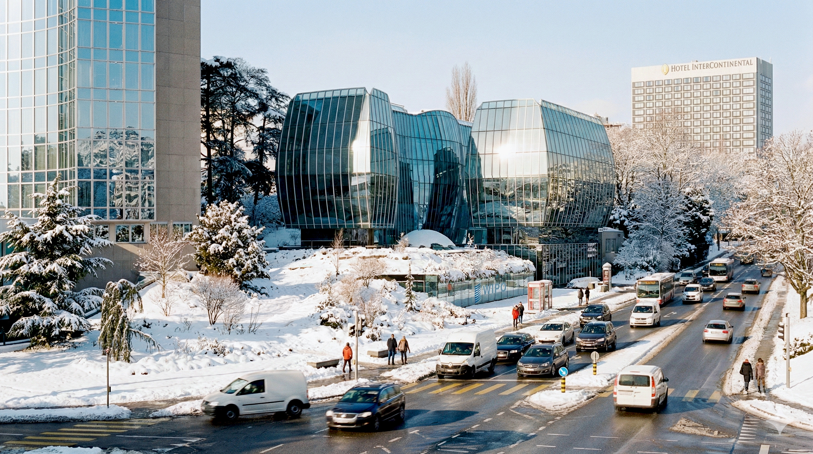 Street-level winter view of the WIPO Headquarters sculpted glass volumes against a snow-covered Geneva streetscape