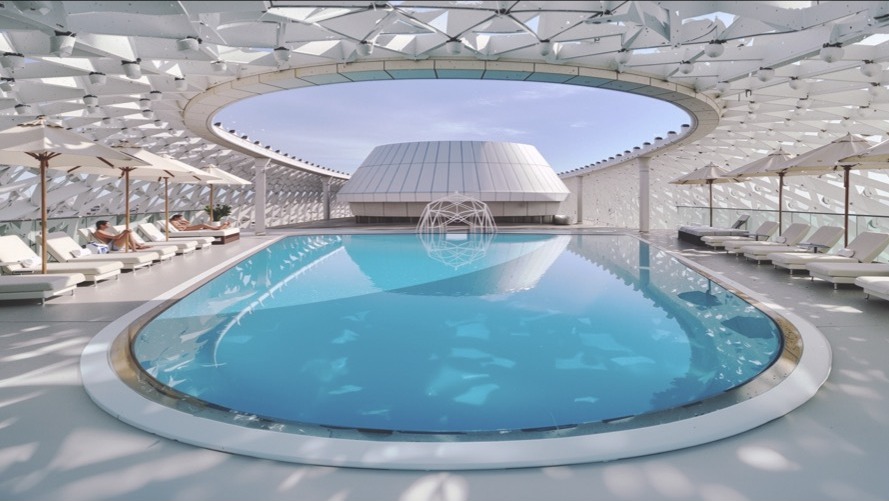 Rooftop pool under the grid-shell canopy with a circular oculus open to the sky