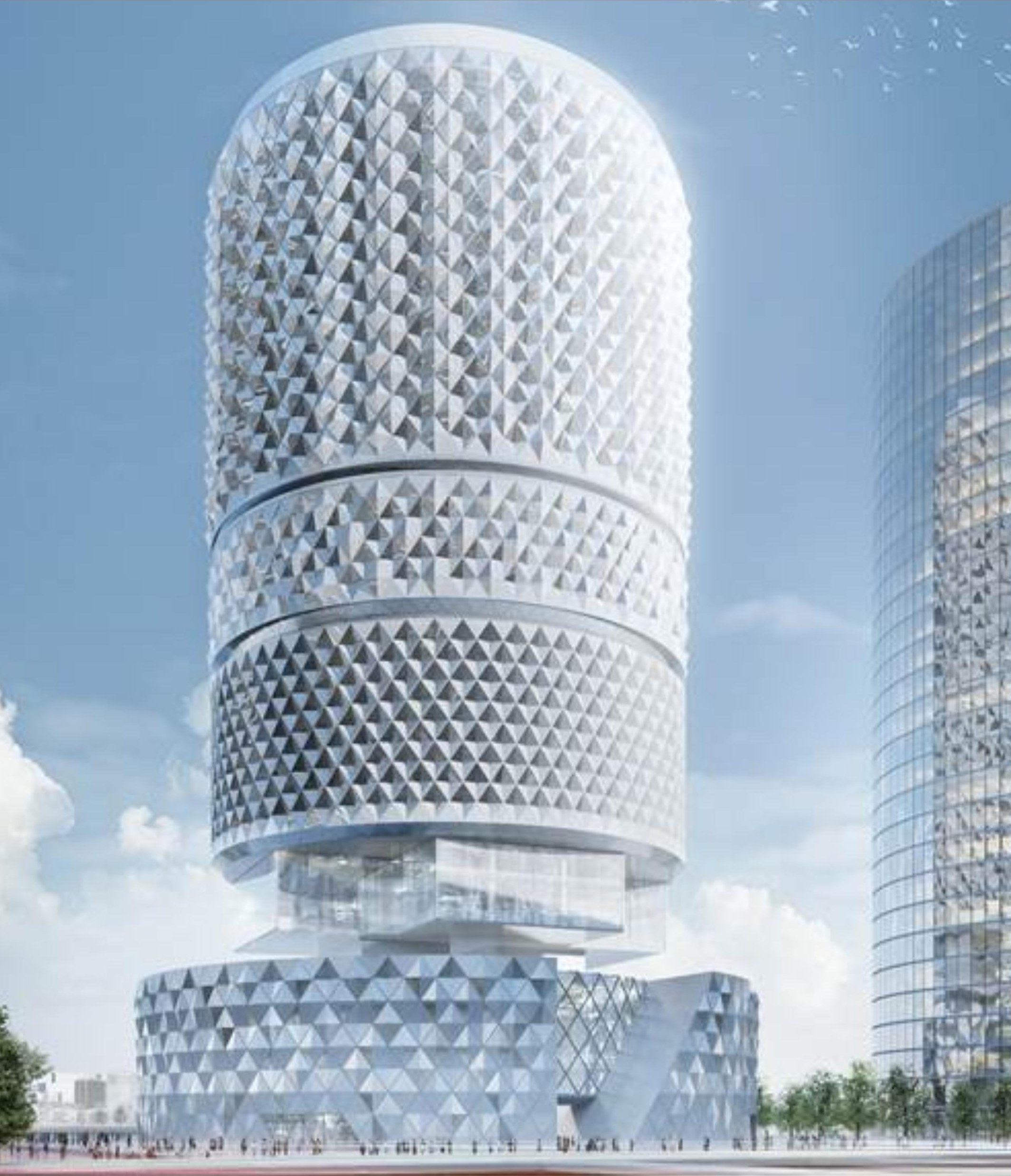 Daytime view of the Zhengzhou CBD Tower — the cylindrical form rising above a diamond-clad plinth, a second tower visible beyond, against a clear sky