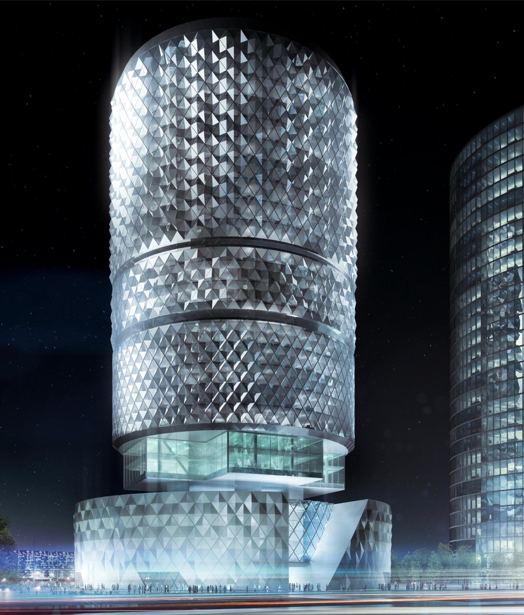 Night view of the Zhengzhou CBD Tower — the full cylindrical volume illuminated against the dark sky, diamond-patterned cladding glowing, the carved plinth and cantilevered entry visible at the base